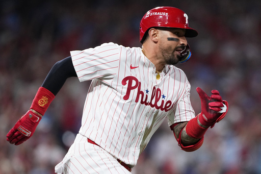Philadelphia Phillies' Nick Castellanos runs after hitting a double to score Alec Bohm and J.T. Realmuto during the ninth inning in Game 2 of baseball's National League Division Series against the Los Angeles Dodgers, Monday, Oct. 6, 2025, in Philadelphia. (AP Photo/Matt Slocum) Philadelphia Phillies' Nick Castellanos runs after hitting a double to score Alec Bohm and J.T. Realmuto during the ninth inning in Game 2 of baseball's National League Division Series against the Los Angeles Dodgers, Monday, Oct. 6, 2025, in Philadelphia. (AP Photo/Matt Slocum)