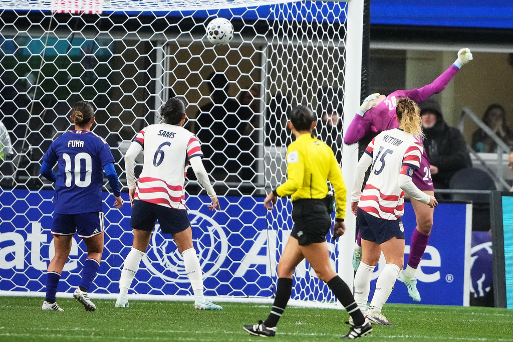United States goalkeeper Phallon Tullis-Joyce can't make the save against a goal from Japan midfielder Maika Hamano as midfielder Fuka Nagano (10) looks on with United States' Emily Sams (6) during the first half of an international friendly soccer match Tuesday, April 14, 2026, in Seattle. (AP Photo/Lindsey Wasson)