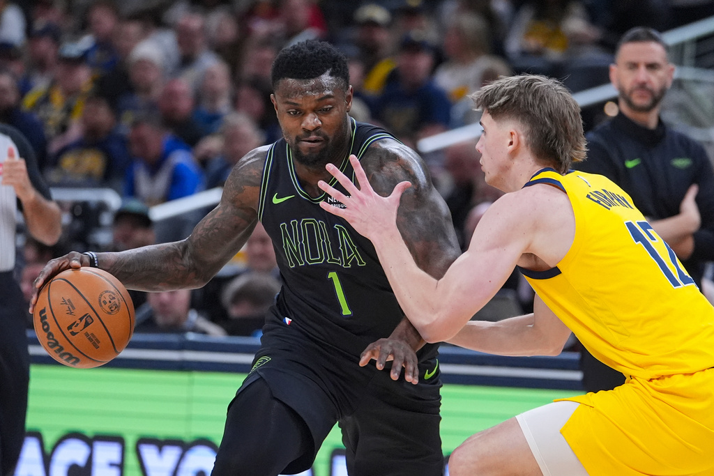 New Orleans Pelicans forward Zion Williamson (1) drives on Indiana Pacers guard Johnny Furphy (12) during the first half of an NBA basketball game in Indianapolis, Friday, Jan. 16, 2026. (AP Photo/Michael Conroy)