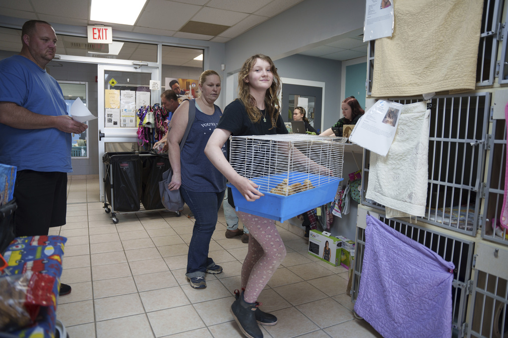 The Bruzdzinski family adopt chicks at First State Animal Center and SPCA on Friday, May 16, 2025, in Camden, Del. (AP Photo/Mingson Lau)