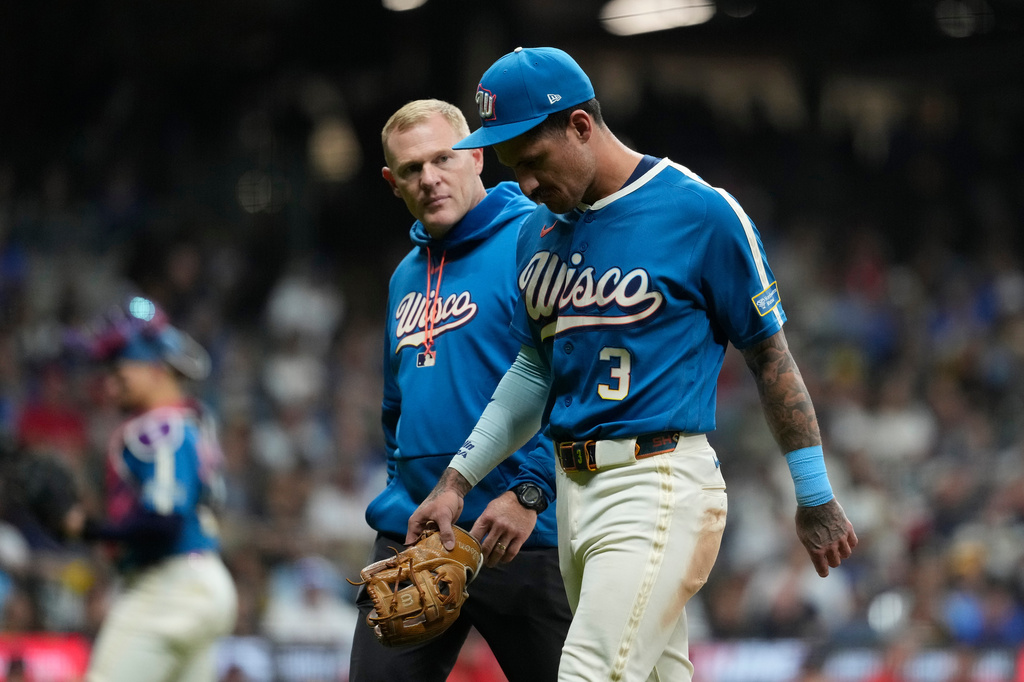 Milwaukee Brewers' Joey Ortiz exits the field with a trainer after suffering an injury during the eighth inning of a baseball game against the St. Louis Cardinals, Friday, Sept. 25, 2026, in Milwaukee. (AP Photo/Aaron Gash)