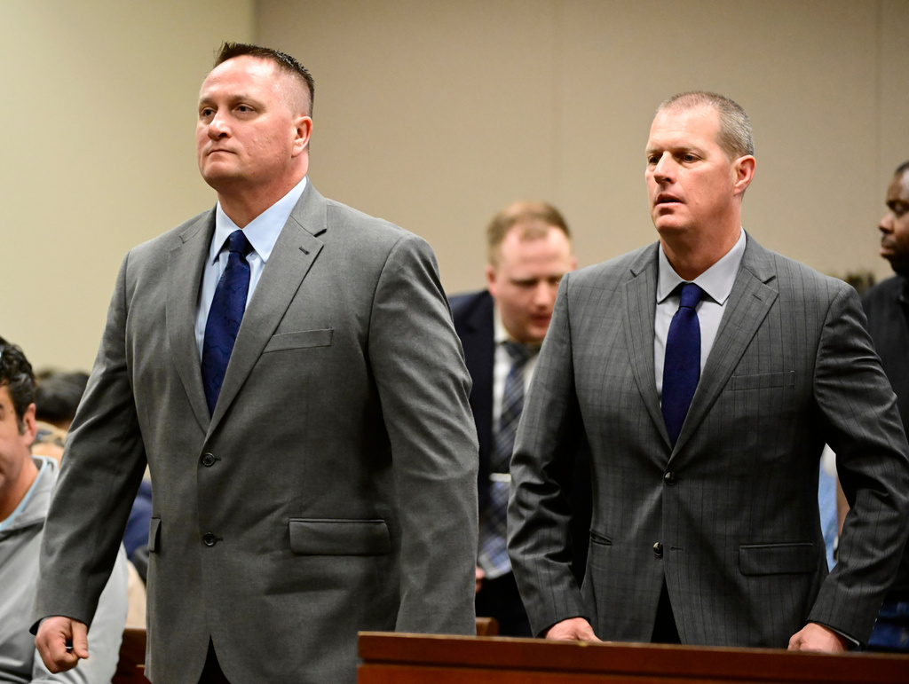 Paramedics Jeremy Cooper, left, and Peter Cichuniec, right, attend an arraignment at the Adams County Justice Center in Brighton, Colo., on Jan. 20, 2023. (Andy Cross/The Denver Post via AP, file)