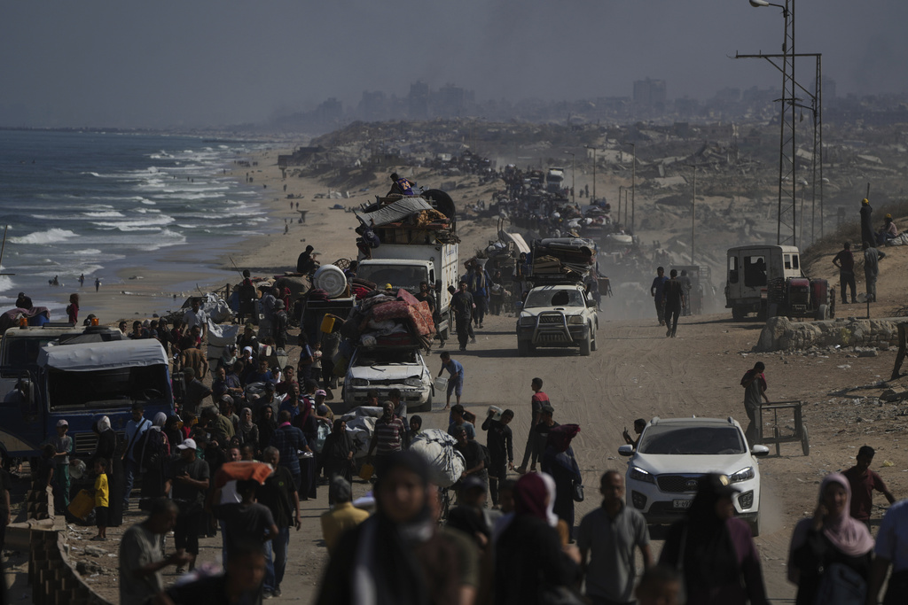 Displaced Palestinians flee Gaza City by foot and vehicles, carrying their belongings along the coastal road toward southern Gaza, Wednesday, Sept. 17, 2025. (AP Photo/Abdel Kareem Hana)