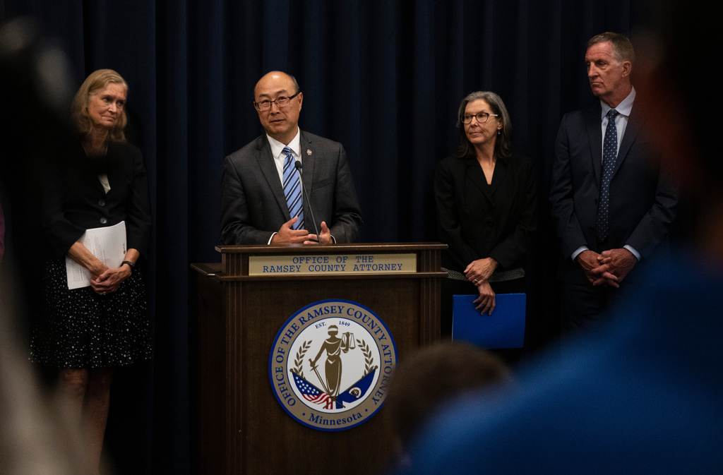 FILE - Ramsey County Attorney John Choi, at podium, discusses his office's review of former Ramsey County Medical Examiner Michael McGee's work during a news conference in St. Paul, Minn., Sept. 11, 2024.(John Autey/Pioneer Press via AP, File)