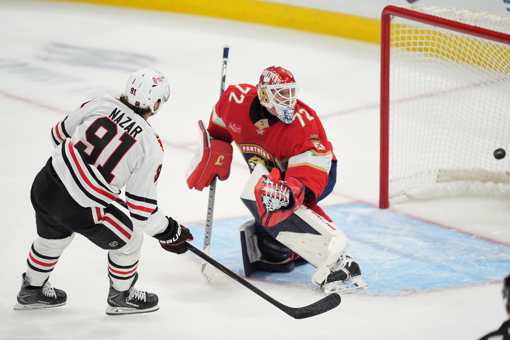 Chicago Blackhawks center Frank Nazar (91) scores on Florida Panthers goaltender Sergei Bobrovsky (72) during the first period of an NHL hockey game, Tuesday, Oct. 7, 2025, in Sunrise, Fla. (AP Photo/Rebecca Blackwell)