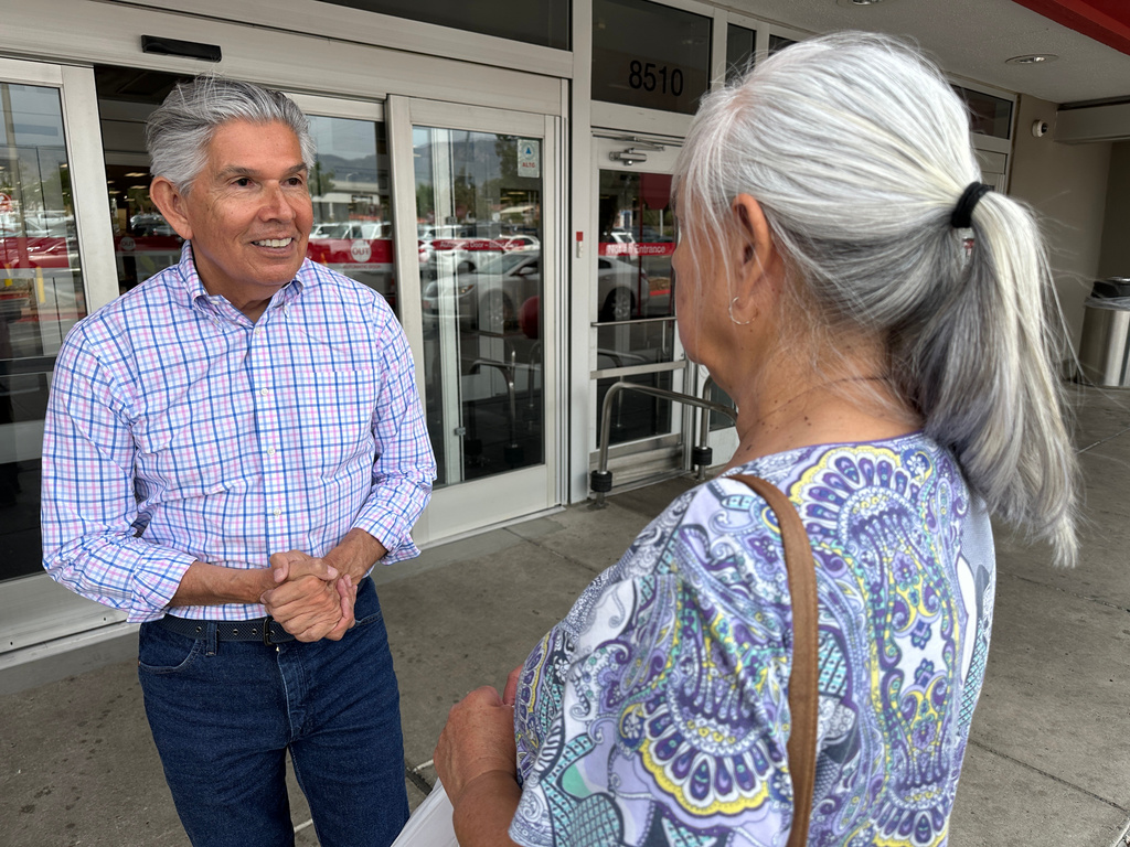 Republican gubernatorial candidate Duke Rodriguez talks with a voter in Albuquerque, N.M., Tuesday, June 2, 2026. (AP Photo/Susan Montoya Bryan)