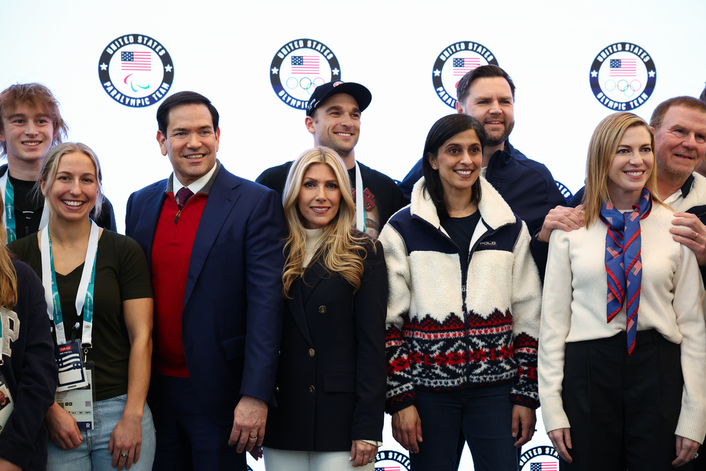 Vice President JD Vance, second lady Usha Vance, Secretary of State Marco Rubio his wife Jeanette Dousdebes Rubio and U.S. Ambassador to Italy and San Marino Tilman Fertitta pose for a photo with Team USA athletes, at the Team USA Welcome Experience, ahead of the Milano Cortina 2026 Winter Olympics in Milan, Italy, Thursday, Feb. 5, 2026. (Kevin Lamarque/Pool Photo via AP)
