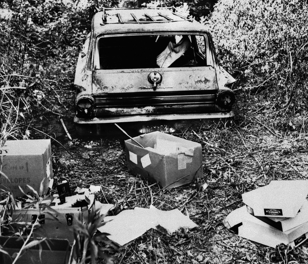 FILE - The burned station wagon of three missing civil rights workers, Michael Schwerner, Andrew Goodman, and James Chaney, in a swampy area near Philadelphia, Miss., June 24, 1964. The bodies of the men were found later in an earthen dam. (AP Photo/Jack Thornell, File)