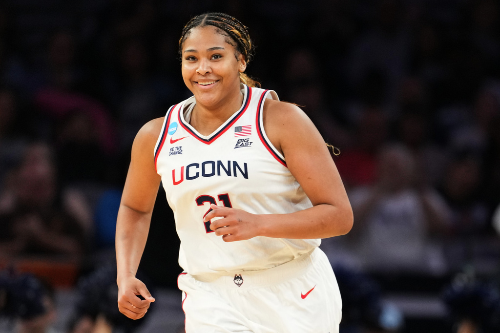 UConn forward Sarah Strong smiles after sinking a basket in the second half in the Sweet 16 of the NCAA college basketball tournament against North Carolina, Friday, March 27, 2026, in Fort Worth, Texas. (AP Photo/Julio Cortez)