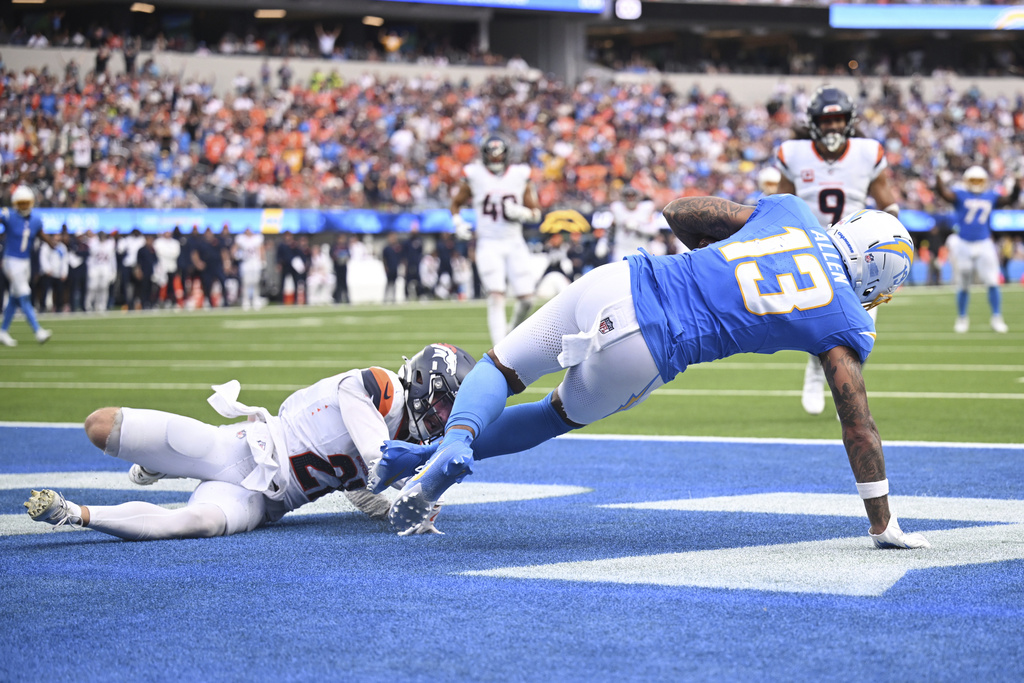 Los Angeles Chargers wide receiver Keenan Allen (13) catches a touchdown past Denver Broncos cornerback Riley Moss (21) during the second half an NFL football game Sunday, Sept. 21, 2025, in Inglewood, Calif. (AP Photo/Carrie Giordano)