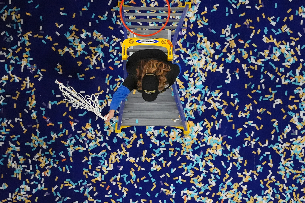 UCLA head coach Cori Close celebrates after cutting down the net after UCLA defeated South Carolina in the women's National Championship Final Four NCAA college basketball tournament game, Sunday, April 5, 2026, in Phoenix. (AP Photo/Ross D. Franklin)