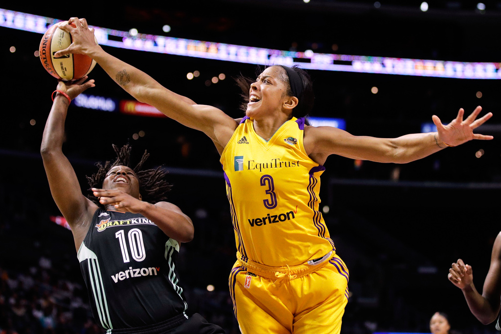 FILE - Los Angeles Sparks' Candace Parker, right, blocks a shot by New York Liberty's Epiphanny Prince during the second half of a WNBA basketball game, Aug. 4, 2017, in Los Angeles. (AP Photo/Jae C. Hong, File)