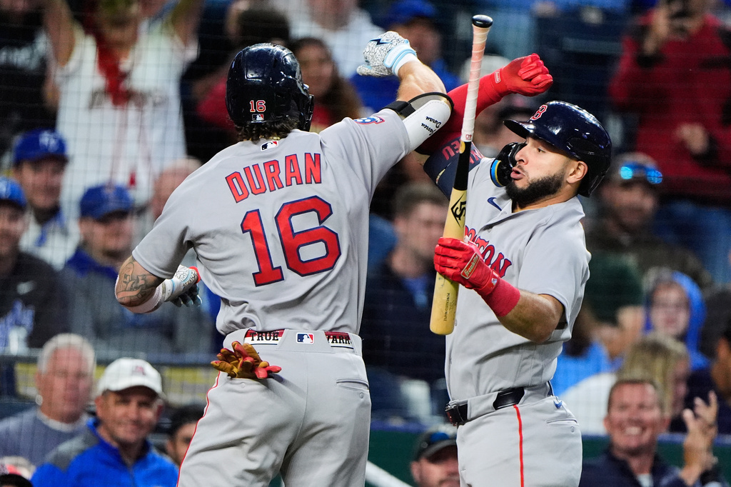 Boston Red Sox's Jarren Duran (16) celebrates with Wilyer Abreu after hitting a two-run home run during the seventh inning of a baseball game against the Kansas City Royals, Wednesday, May 20, 2026, in Kansas City, Mo. (AP Photo/Charlie Riedel)