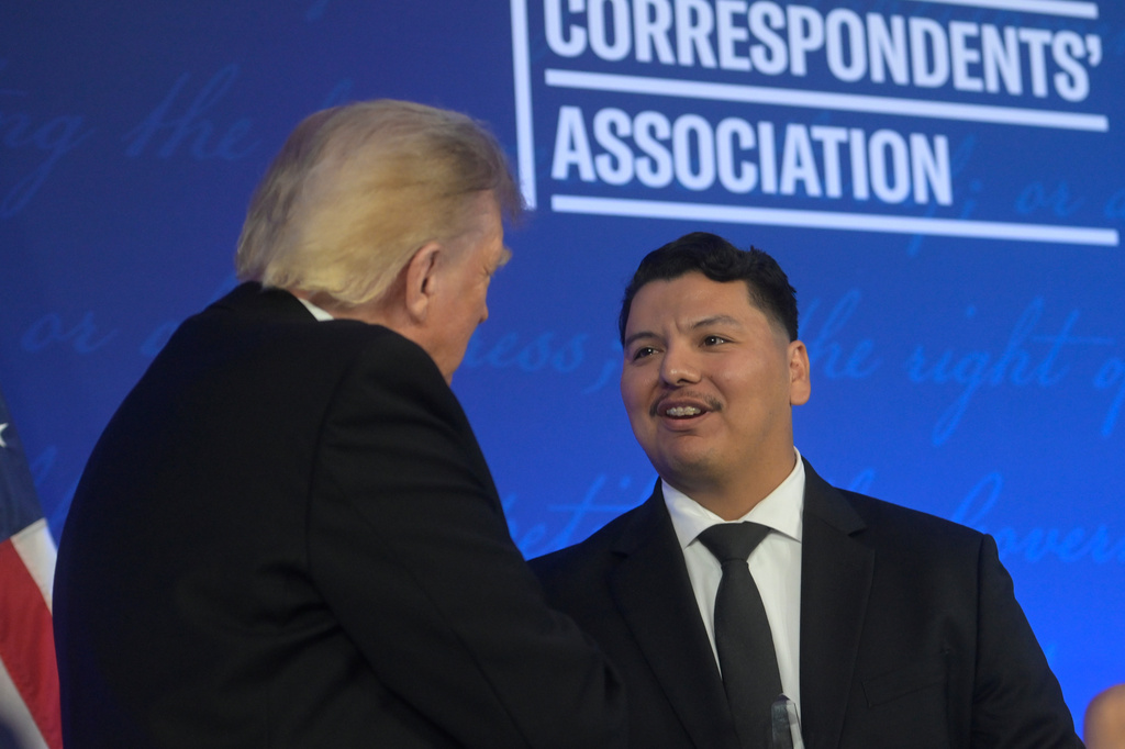 President Donald Trump greets U.S. Secret Service agent Victor Gonzalez at the White House Correspondents' Association dinner at the Waldorf Astoria Washington DC, Friday, July 24, 2026, in Washington. (AP Photo/Rod Lamkey, Jr.)