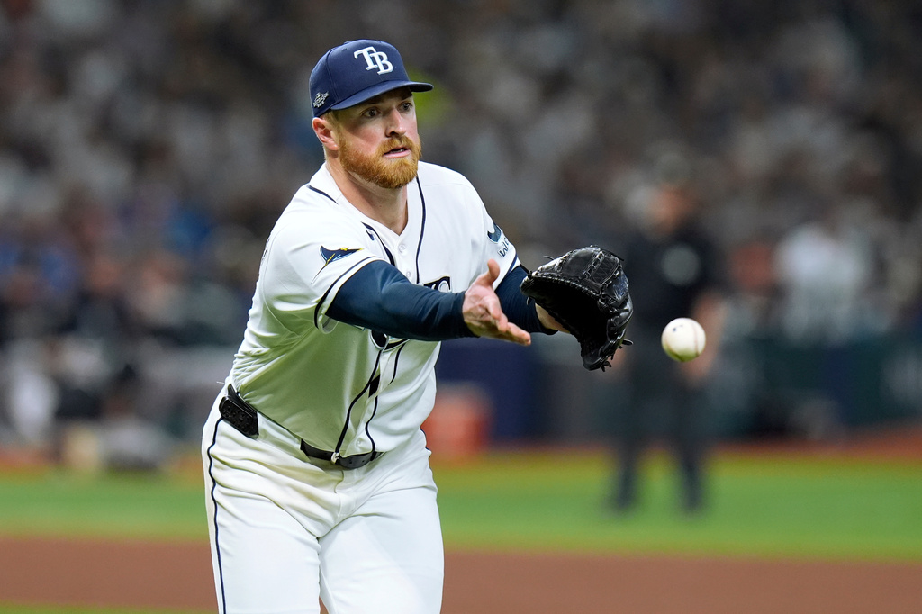 Tampa Bay Rays pitcher Drew Rasmussen tosses the ball to first base to throw out New York Yankees' Ryan McMahon on an attempted bunt during the sixth inning of Game 1 of an American League Division Series baseball game Saturday, Oct. 3, 2026, in St. Petersburg, Fla. (AP Photo/Chris O'Meara)