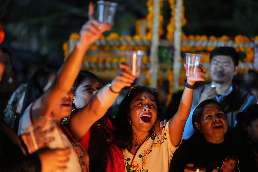 Families gather to keep company with their dearly departed celebrating the Day of the Dead at the cemetery of Tzintzuntzan, Michoacan state, Mexico, Friday, Oct. 31, 2025. (AP Photo/Eduardo Verdugo)