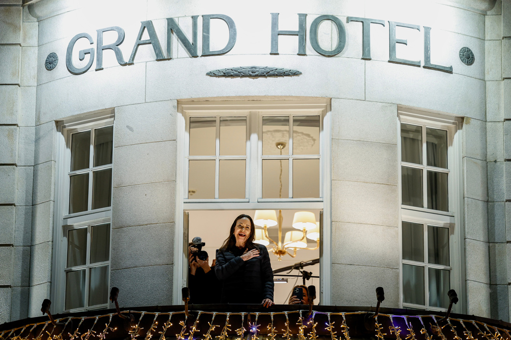 Nobel Peace Prize laureate Maria Corina Machado reacts to the crowd gathered below from a balcony at the Grand Hotel, in Oslo, Norway, early Thursday, Dec. 11, 2025. (Jonas Been Henriksen/NTB Scanpix via AP)