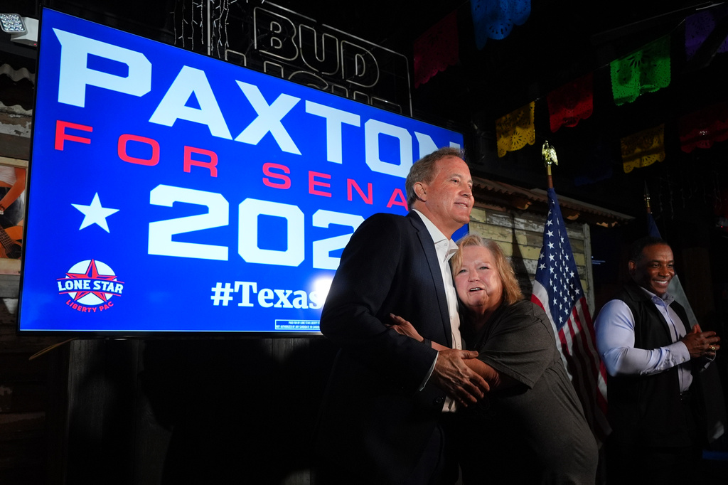 Vickie Palmer, right, hugs Texas Attorney General Ken Paxton, a Republican candidate for the U.S. Senate, at a campaign event in McKinney, Texas, Tuesday, May 19, 2026. (AP Photo/LM Otero)
