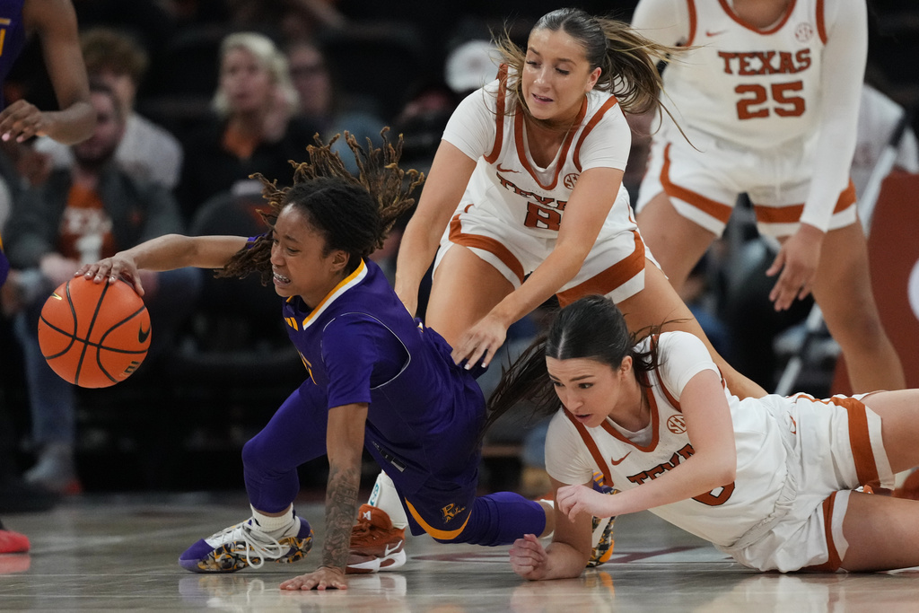 Prairie View A&M guard Margan Allen, left, chases a loose ball in front of Texas guard Grace Prenter (8) and guard Sarah Graves, right, during the second half of an NCAA college basketball game in Austin, Texas, Sunday, Dec. 7, 2025. (AP Photo/Eric Gay)