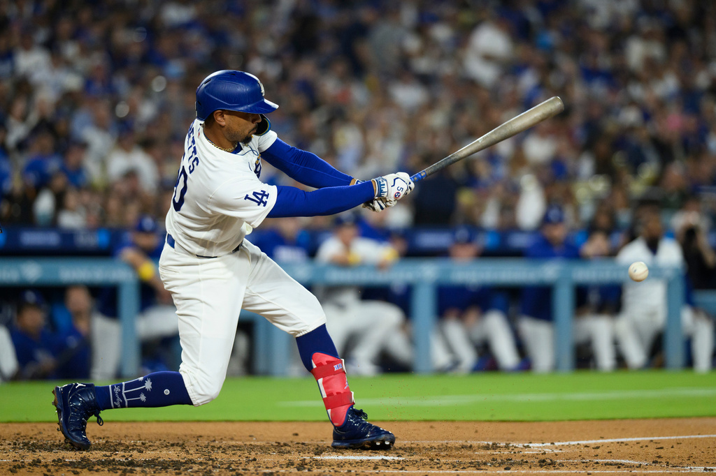 Los Angeles Dodgers' Mookie Betts hits for an RBI groundout during the third inning of a baseball game against the Washington Nationals in Los Angeles, Sunday, Sept. 6, 2026. (AP Photo/Kyusung Gong)