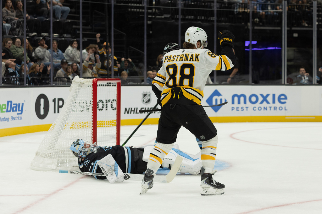 Boston Bruins right wing David Pastrnak (88) celebrates after a goal against Utah Mammoth goalie Vitek Vanecek, left, during the first period of an NHL hockey game Sunday, Oct. 19, 2025, in Salt Lake City. (AP Photo/Melissa Majchrzak)