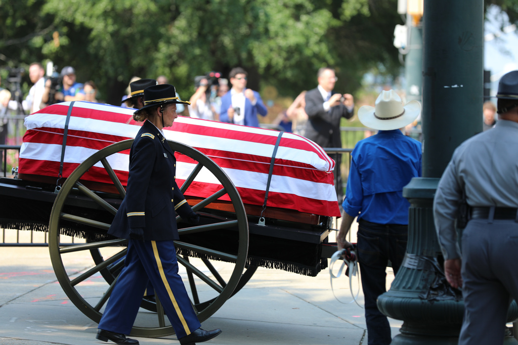 The flag-draped casket of U.S. Sen. Lindsey Graham, R-S.C., is carried on a horse-drawn caisson to his funeral at First Baptist Church in Columbia, S.C., on Wednesday, July 29, 2026. (AP Photo/Jeffrey Collins).