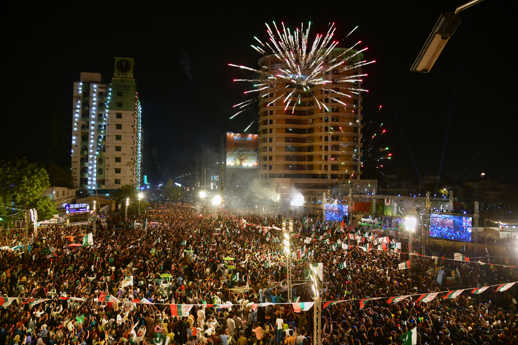 People gather to watch fireworks light the sky marking the Independence Day, in Karachi, Pakistan, Friday, Aug. 14, 2026. (AP Photo/Ali Raza)