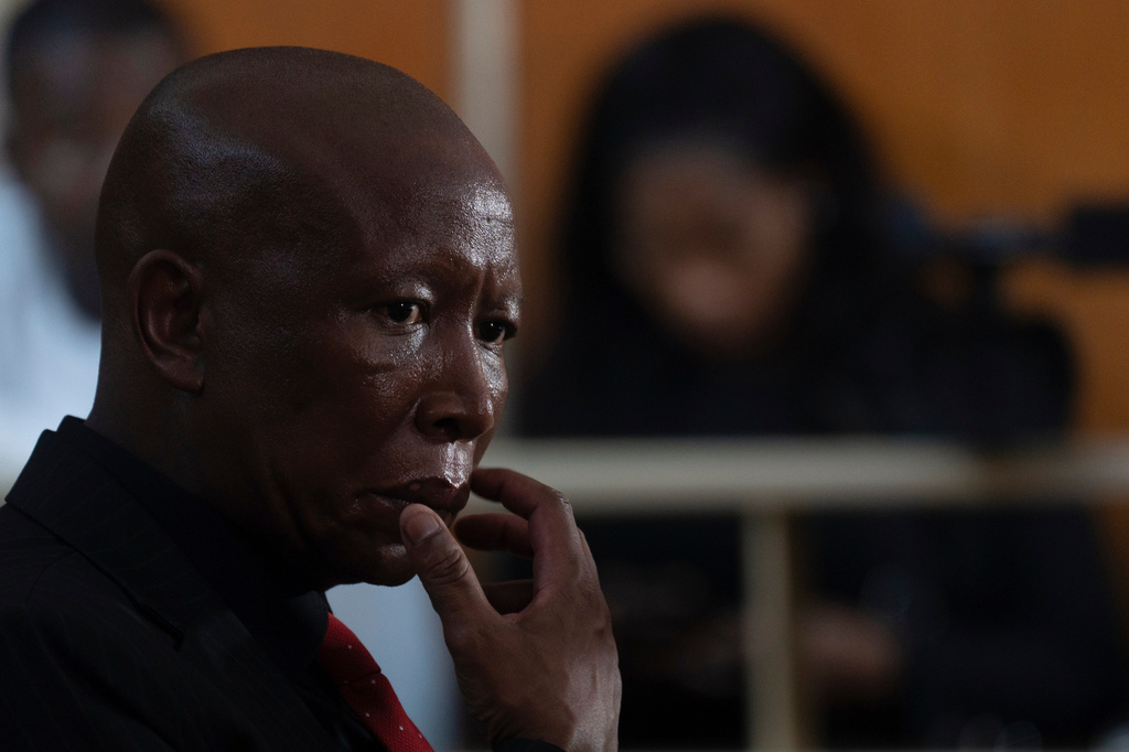 Julius Malema, leader of the Economic Freedom Fighters party, sits in a courtroom during sentencing for firing a rifle at a political rally, in East London, South Africa, Thursday, April 16, 2026. (AP Photo)