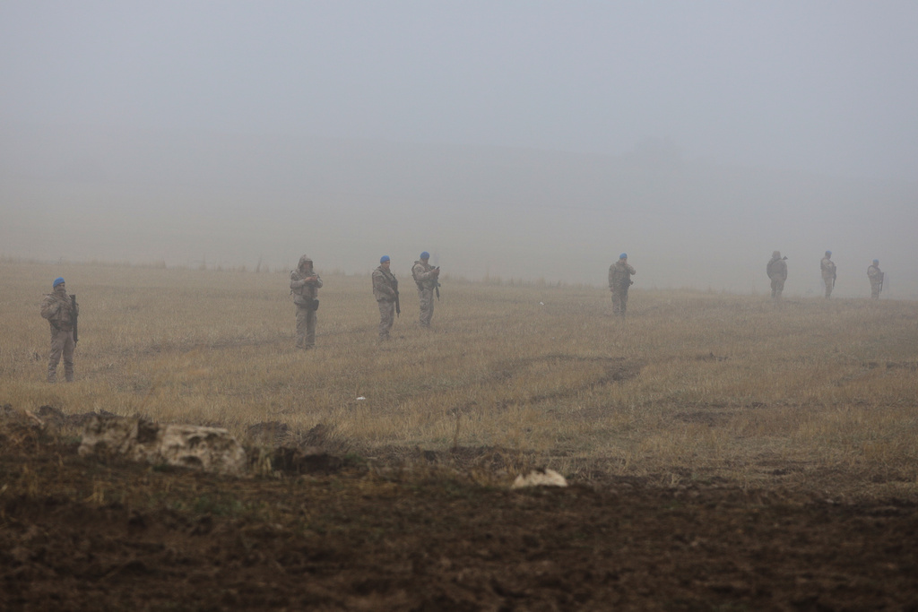 Turkish army soldiers stand guard as rescue teams search for the remains of a private jet carrying Libya's military chief and four others that crashed after taking off from Ankara, killing everyone on board, in Ankara, Turkey, early Wednesday, Dec. 24, 2025. (AP Photo/Efekan Akyuz)