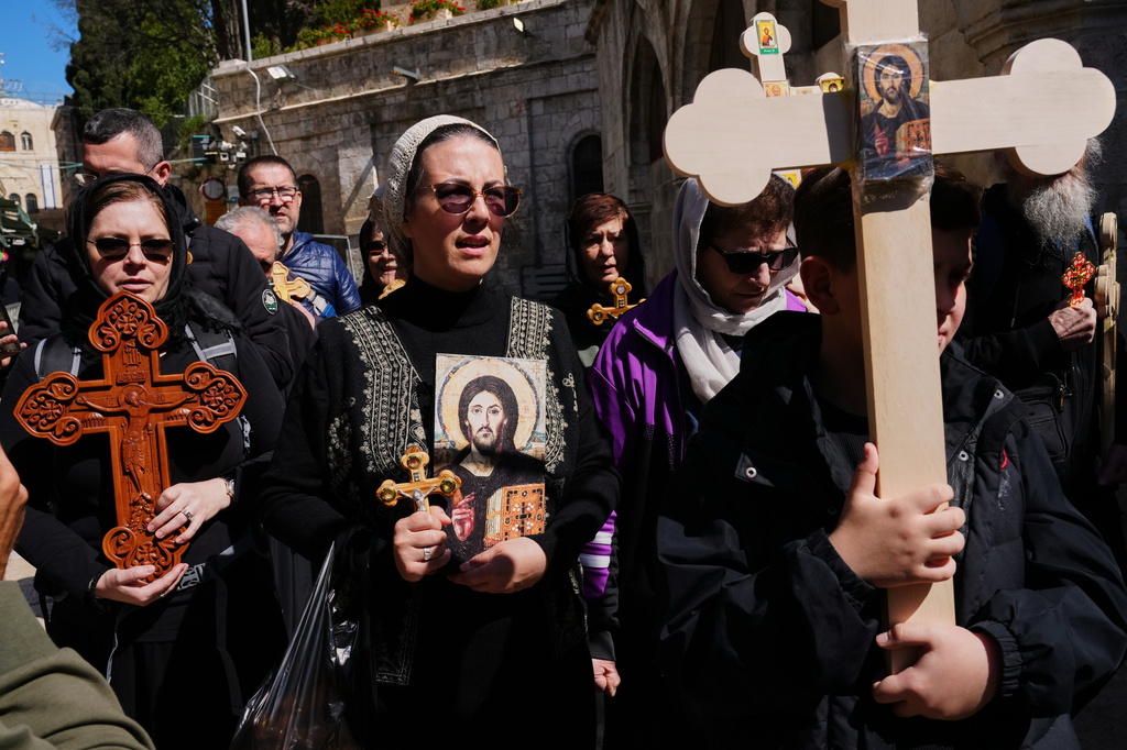 Orthodox Christian pilgrims carry crosses during Good Friday procession in the Old City of Jerusalem on Friday, April 10, 2026. (AP Photo/Mahmoud Illean)