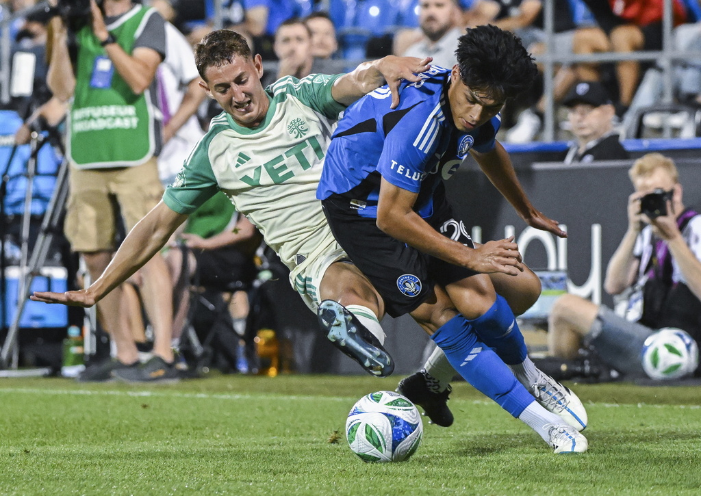 Austin FC's Nico Dubersarsky, left, challenges CF Montreal's Olger Escobar (29) during the second half of an MLS soccer game in Montreal, Saturday, Aug. 23, 2025. (Graham Hughes/The Canadian Press via AP)
