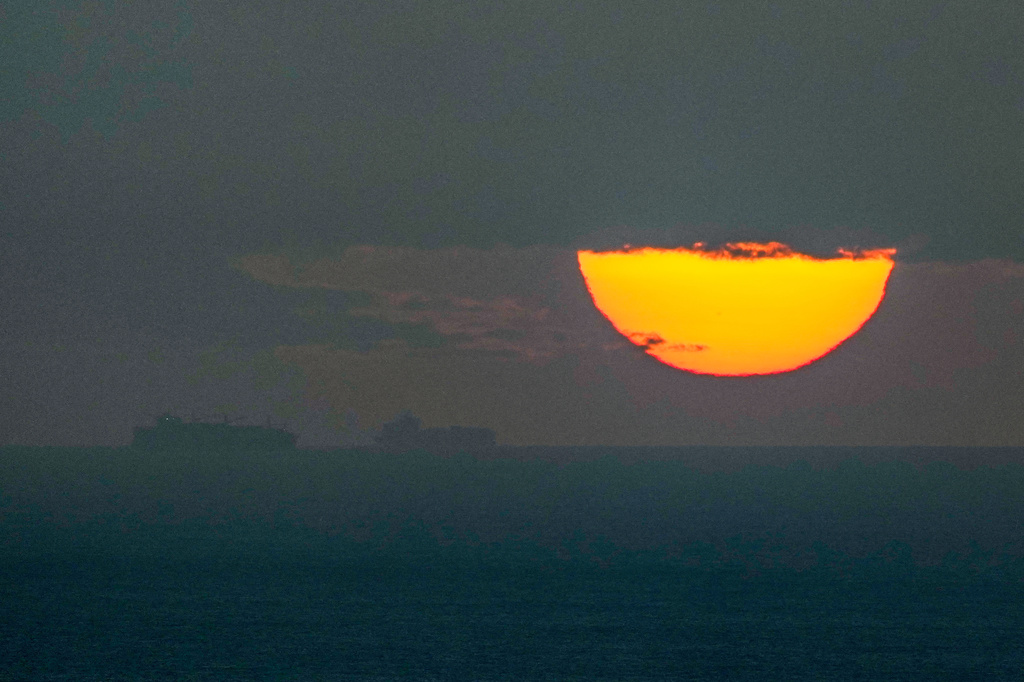 FILE - Ships sail through the Arabian Gulf toward the Strait of Hormuz as the sun sets in the United Arab Emirates Monday, March 23, 2026. (AP Photo, File)