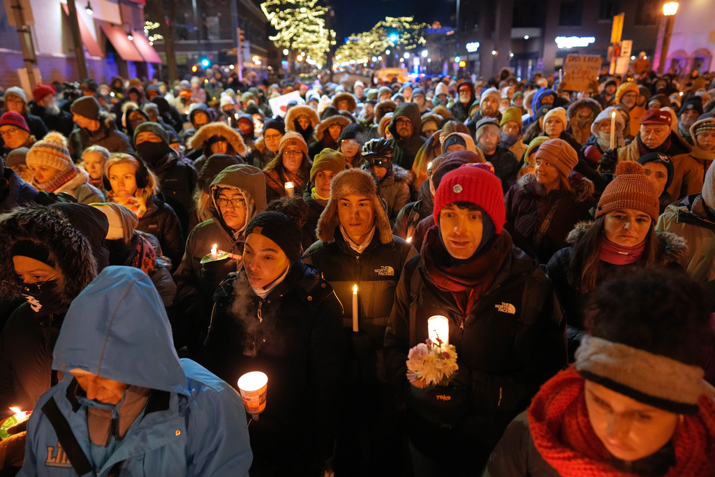 People gather during a vigil where Alex Pretti was shot and killed by federal immigration enforcement in Minneapolis, on Wednesday, Jan. 28, 2026. (AP Photo/Adam Gray)