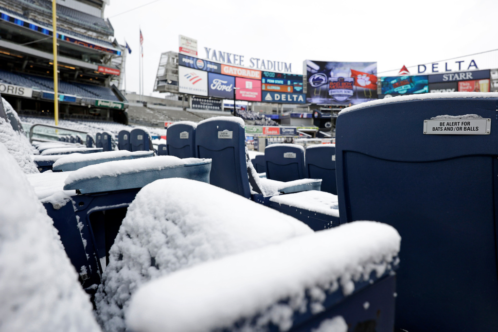 Snow covered seats are seen before the Pinstripe Bowl NCAA college football game between Clemson and Penn State at Yankee Stadium Saturday, Dec. 27, 2025, in New York. (AP Photo/Adam Hunger)