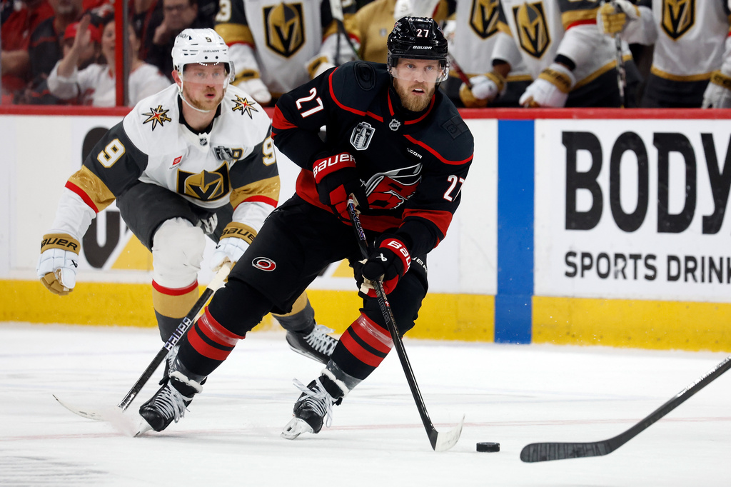 Carolina Hurricanes' Nikolaj Ehlers (27) controls the puck while followed by Vegas Golden Knights' Jack Eichel (9) during the second period in Game 2 of the NHL hockey Stanley Cup Final series in Raleigh, N.C., Thursday, June 4, 2026. (AP Photo/Karl DeBlaker)