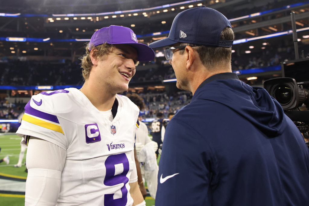 Minnesota Vikings quarterback J.J. McCarthy (9) and Los Angeles Chargers head coach Jim Harbaugh talk after an NFL football game Thursday, Oct. 23, 2025, in Inglewood, Calif. (AP Photo/Jessie Alcheh)