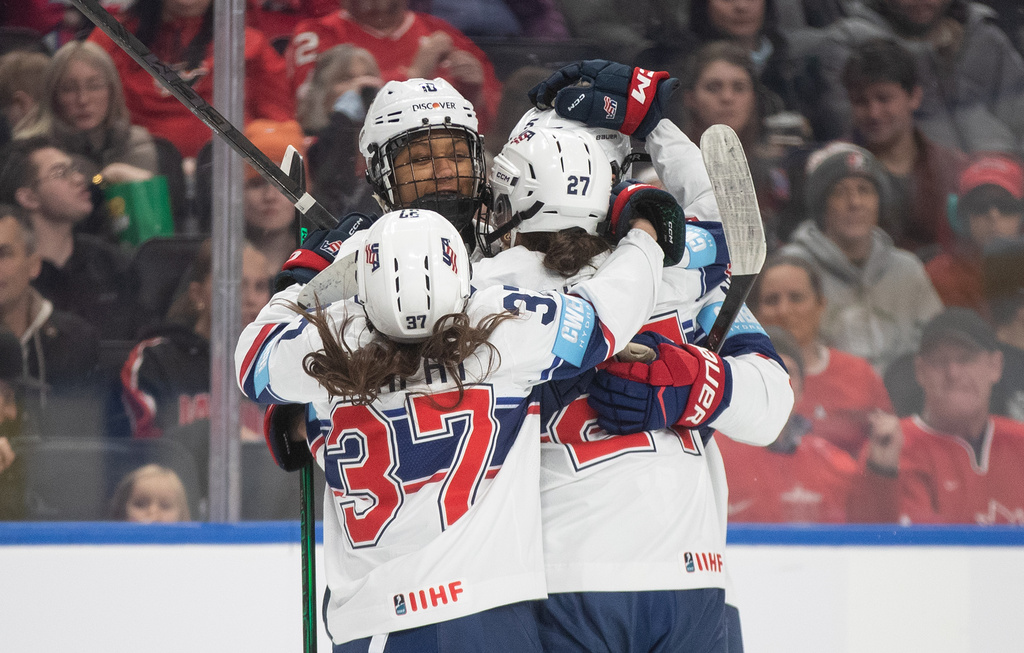 United States' Abbey Murphy (37), Laila Edwards (10) and Taylor Heise (27) celebrate a goal against Canada during second period of a Rivalry Series hockey game in Edmonton, Alberta, Saturday, Dec. 13, 2025. (Jason Franson/The Canadian Press via AP)