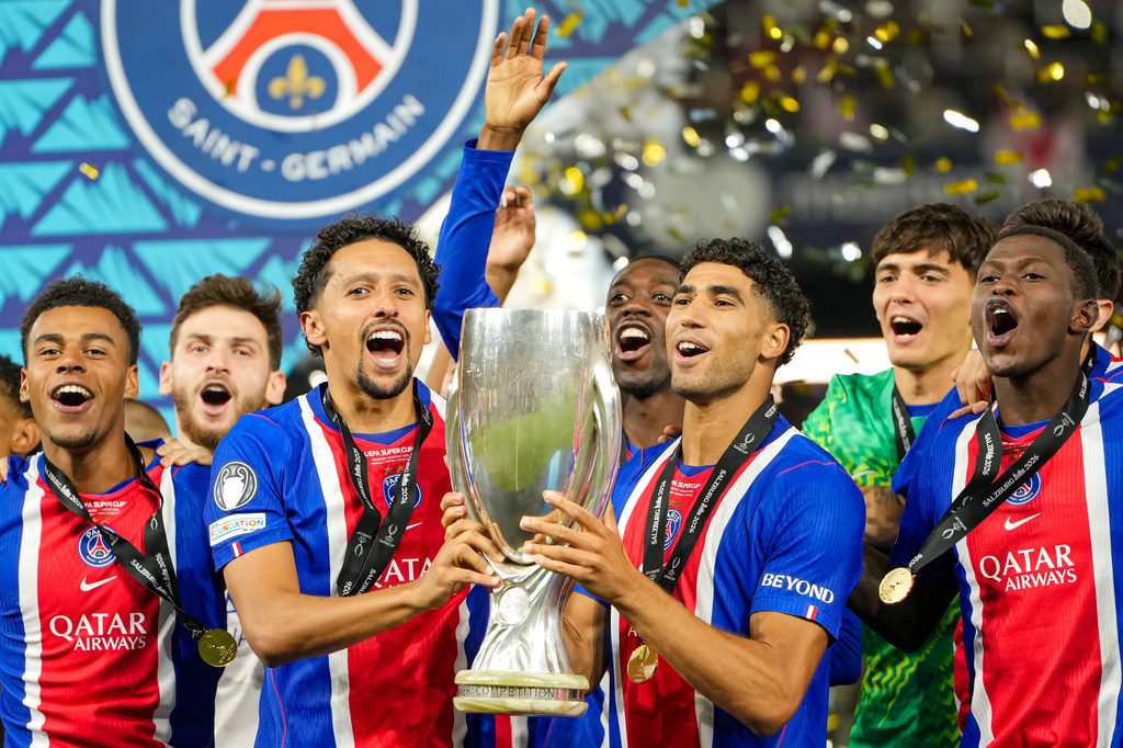PSG's Marquinhos and PSG's Achraf Hakimi lift the trophy during celebrations at the end of the UEFA Super Cup soccer match between Paris Saint-Germain and Aston Villa in Salzburg, Austria, Wednesday, Aug.12, 2026. (AP Photo/Darko Bandic)