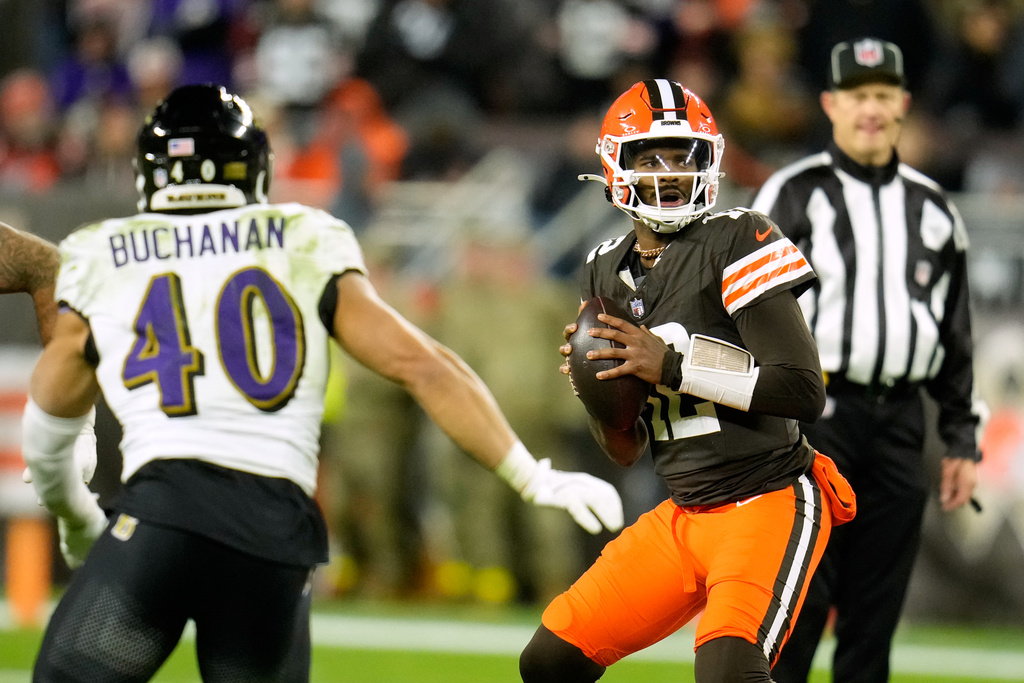 Cleveland Browns quarterback Shedeur Sanders (12) prepares to throw a pass under pressure from Baltimore Ravens linebacker Teddye Buchanan (40) in the second half of an NFL football game in Cleveland, Sunday, Nov. 16, 2025. (AP Photo/Sue Ogrocki)