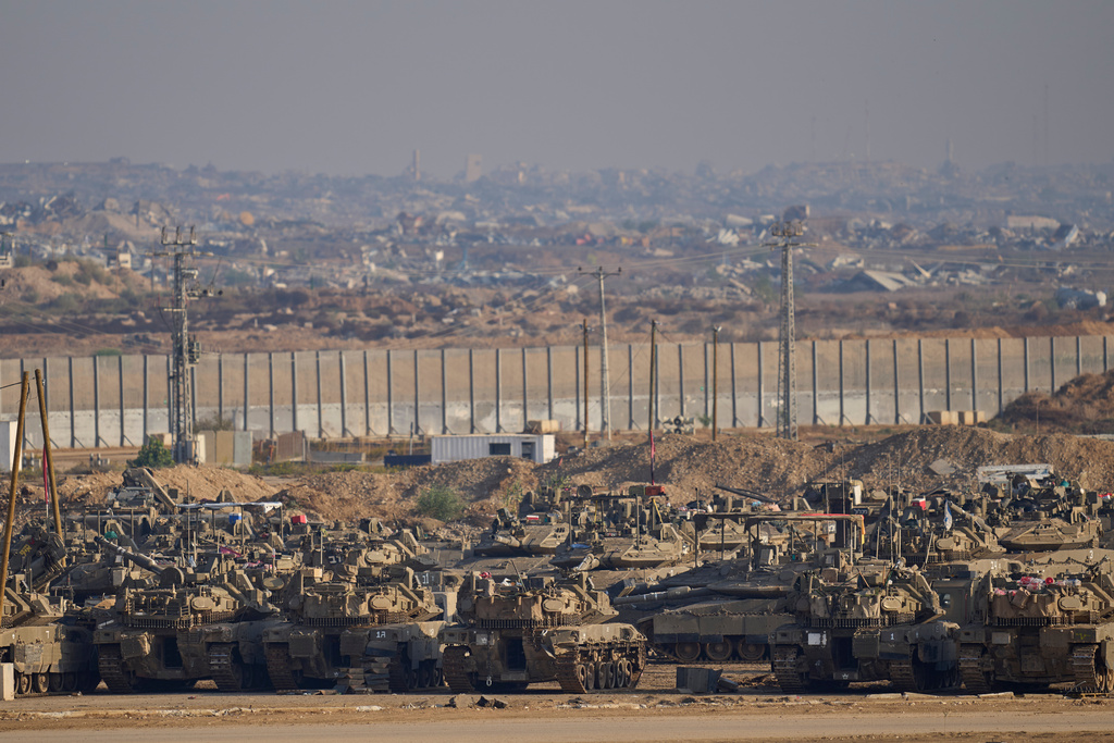 Israeli tanks are parked in a staging area near the border with Gaza, in southern Israel, Tuesday, Nov. 18, 2025. (AP Photo/Ohad Zwigenberg)