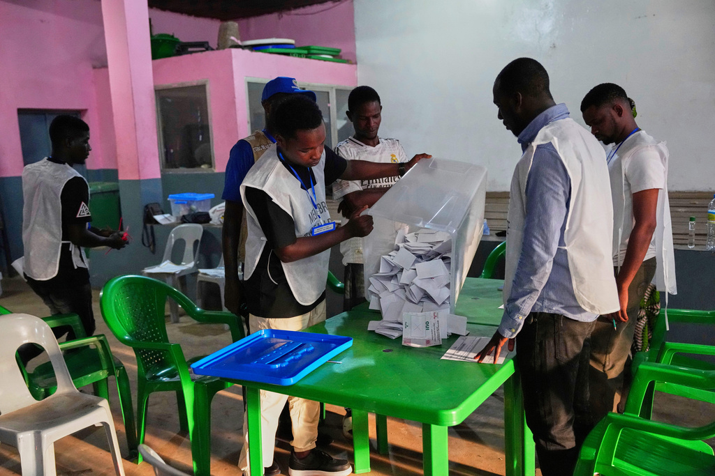 Voting slips are emptied from a ballot box at a polling station as polls close during the constitutional referendum in Conakry, Guinea, Sunday, Sept. 21, 2025. (AP Photo/Misper Apawu)