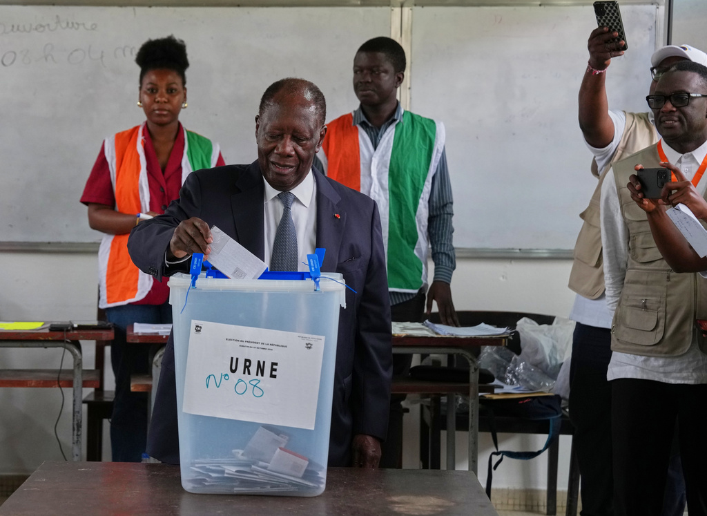Ivory Coast President Alassane Ouattara casts his vote at a polling station during the presidential elections in Abidjan, Ivory Coast, Saturday, Oct. 25, 2025. (AP Photo/Misper Apawu)