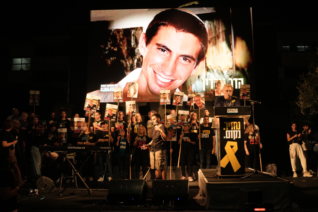 An image of Hadar Goldin, an Israeli soldier killed in 2014 whose body has been held in Gaza since then, is shown during a rally calling for the return of the deceased hostages who are held by Hamas in the Gaza Strip, in Tel Aviv, Israel, Saturday, Nov. 8, 2025. (AP Photo/Mahmoud Illean)