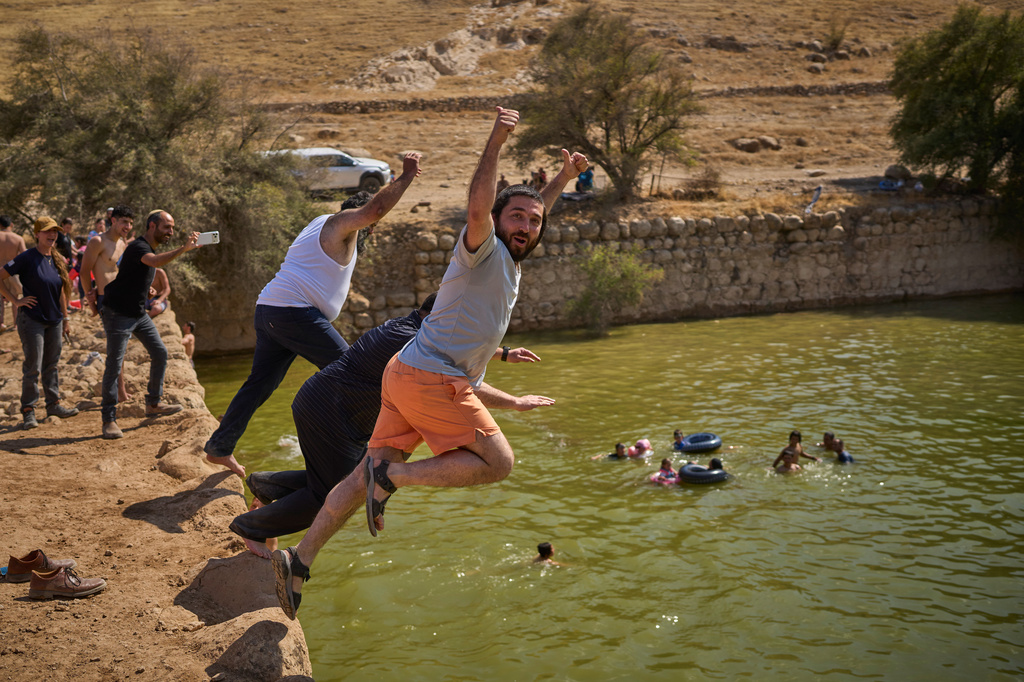 Israeli Knesset member Zvi Sukkot, right, and Minister of Heritage Amichai Eliyahu jump into a pool at an ancient archaeological site known as Herod's Pool, near the Israeli settlement of Petzael, in the occupied West Bank, on June 19, 2026. (AP Photo/Ohad Zwigenberg)