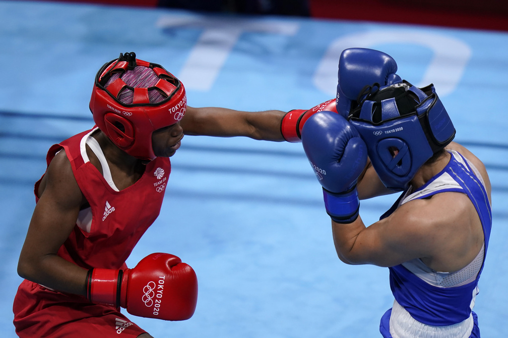 FILE -Caroline Dubois, of Great Britain, left, punches Donjeta Sadiku, of Kosovo, during their light weight (60kg) preliminary boxing match at the 2020 Summer Olympics, July 27, 2021, in Tokyo, Japan. (AP Photo/ Frank Franklin II), File)