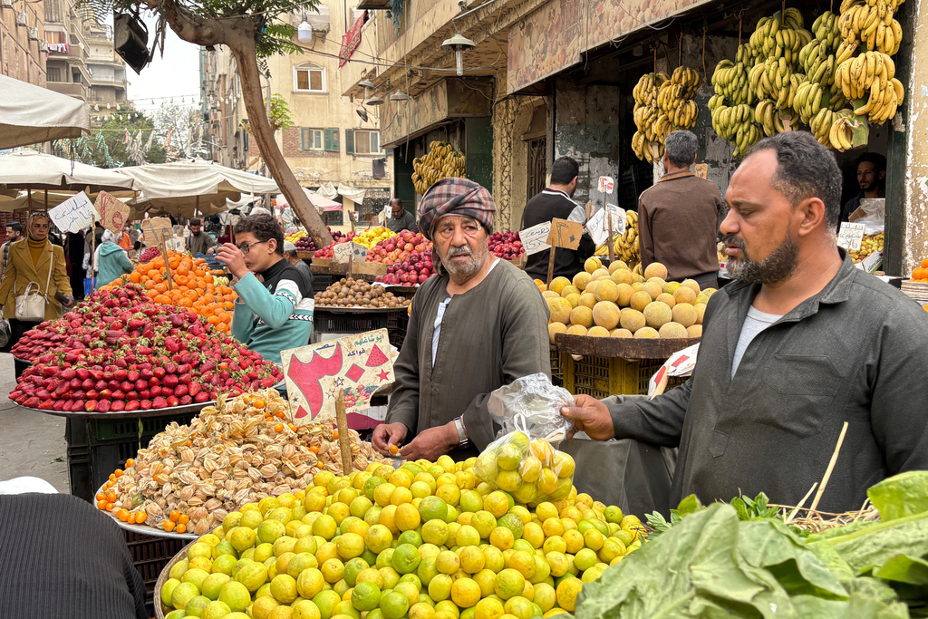 Vendors line up at a popular market in Cairo, Egypt, Tuesday, March 12, 2026. (AP Photo/Amr Nabil)