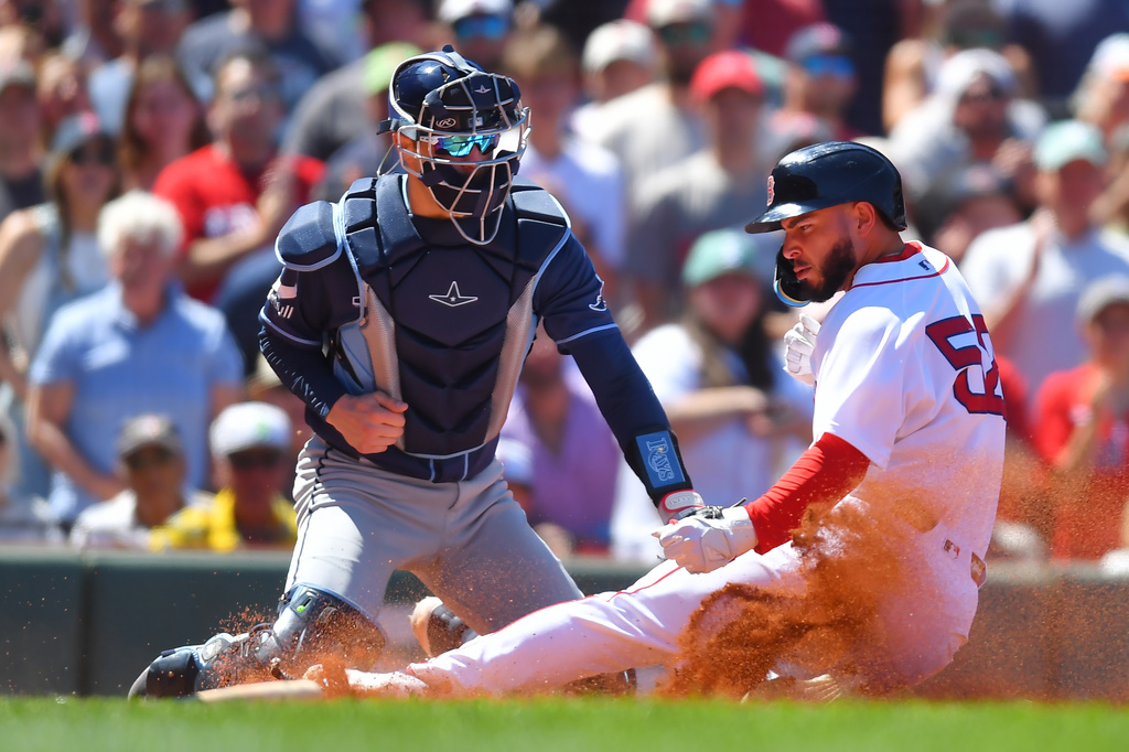 Boston Red Sox's Wilyer Abreu, right, slides safely into home plate to score in front of Tampa Bay Rays catcher Hunter Feduccia, left, after Red Sox's Caleb Durbin grounded into a fielder's choice in the third inning of a baseball game, Sunday, July 19, 2026, in Boston. (AP Photo/Steven Senne)