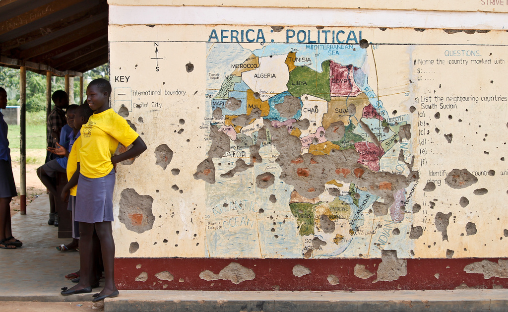 In this photo taken Nov. 15, 2016, students line up outside a classroom with a map of Africa on its wall, in Yei, in southern South Sudan. (AP Photo/Justin Lynch, file)