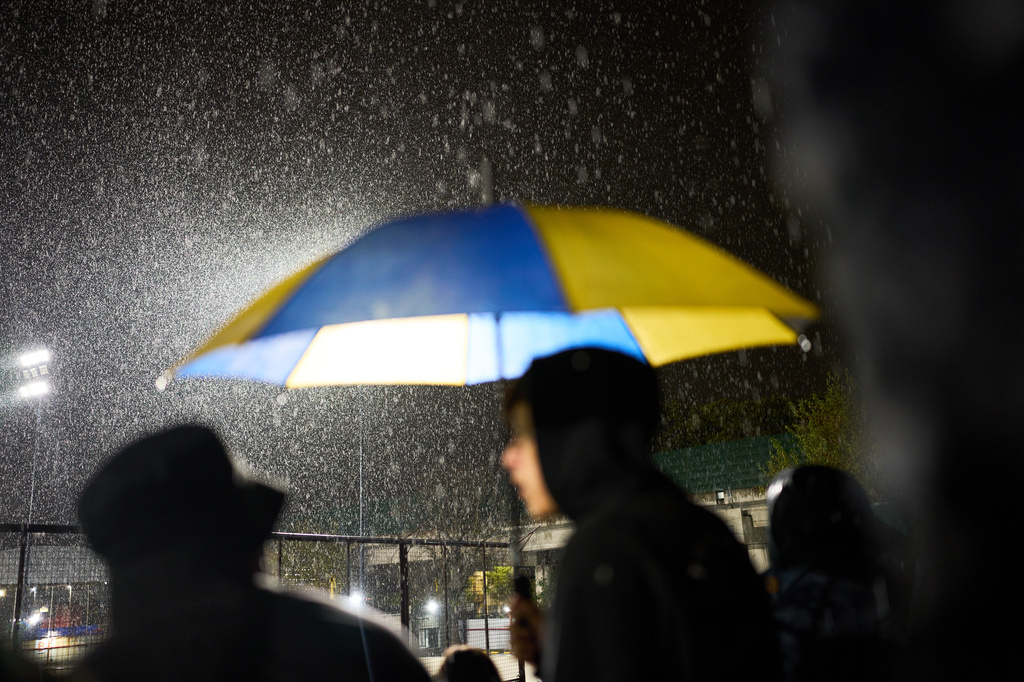 Atlanta fans stand under the rain during an Argentine second-division soccer match against Chacarita Juniors, in Buenos Aires, Argentina, Monday, April 20, 2026. (AP Photo/Rodrigo Abd)