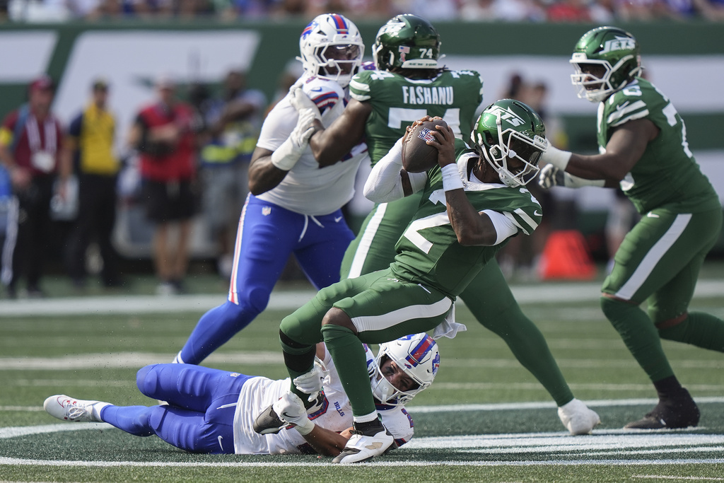 New York Jets quarterback Tyrod Taylor (2) is sacked by Buffalo Bills safety Cole Bishop (24) during the fourth quarter of an NFL football game, Sunday, Sept. 14, 2025, in East Rutherford, N.J. (AP Photo/Frank Franklin)